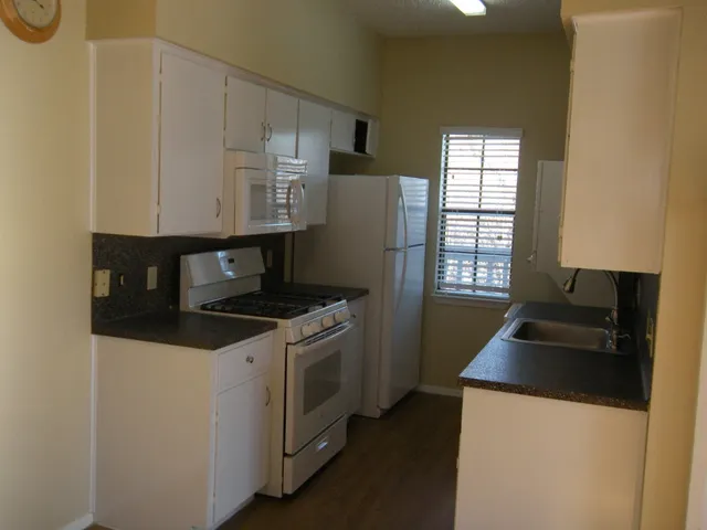 a kitchen with a stove and a refrigerator