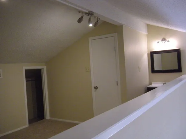 a view of a hallway and a mirror