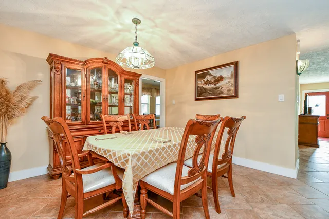 a view of a dining room with furniture and chandelier