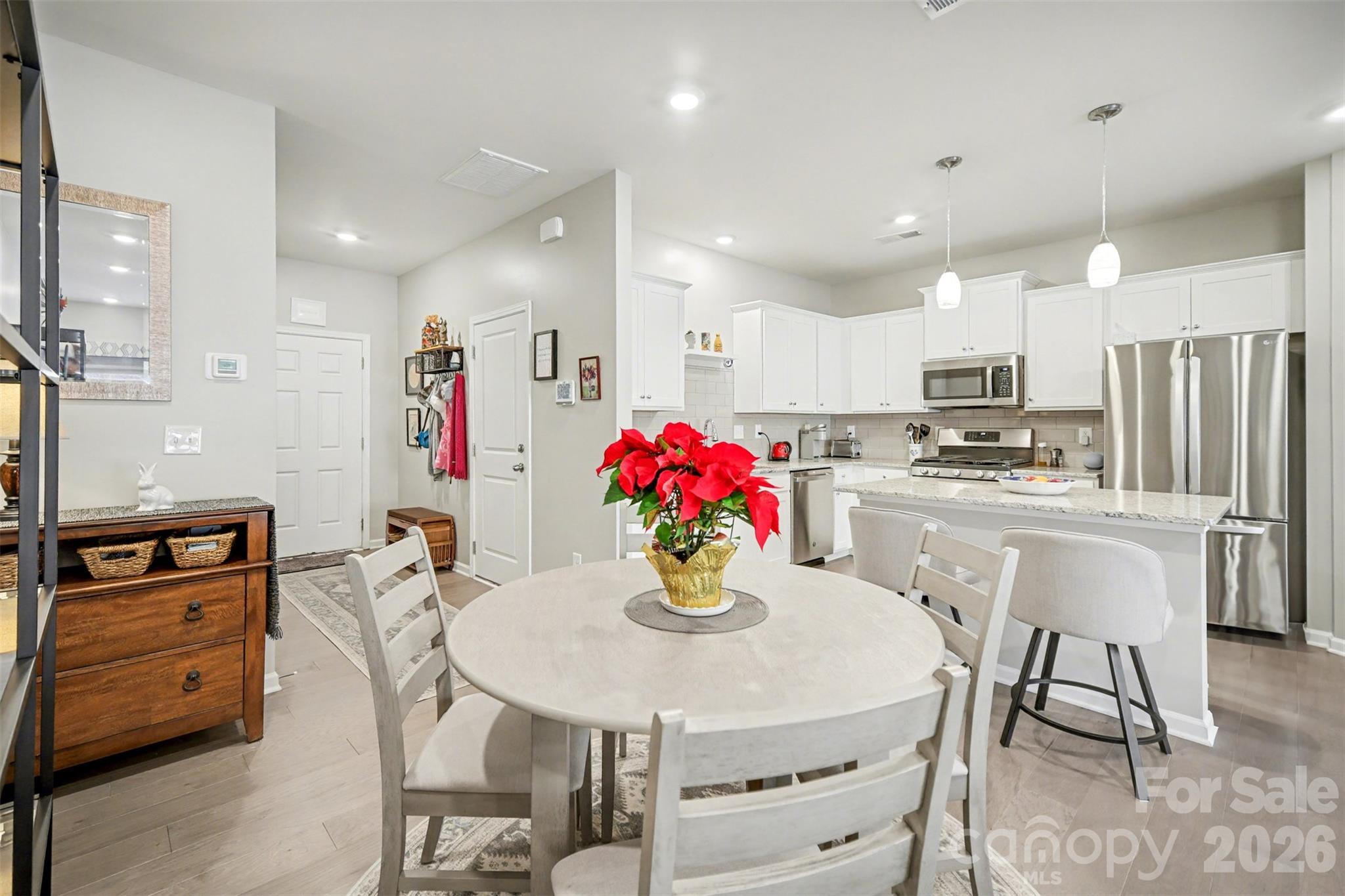 226 Quinn Road Matthews, NC 28104 - Photo 15 of 30 a kitchen with refrigerator a stove and a dining table