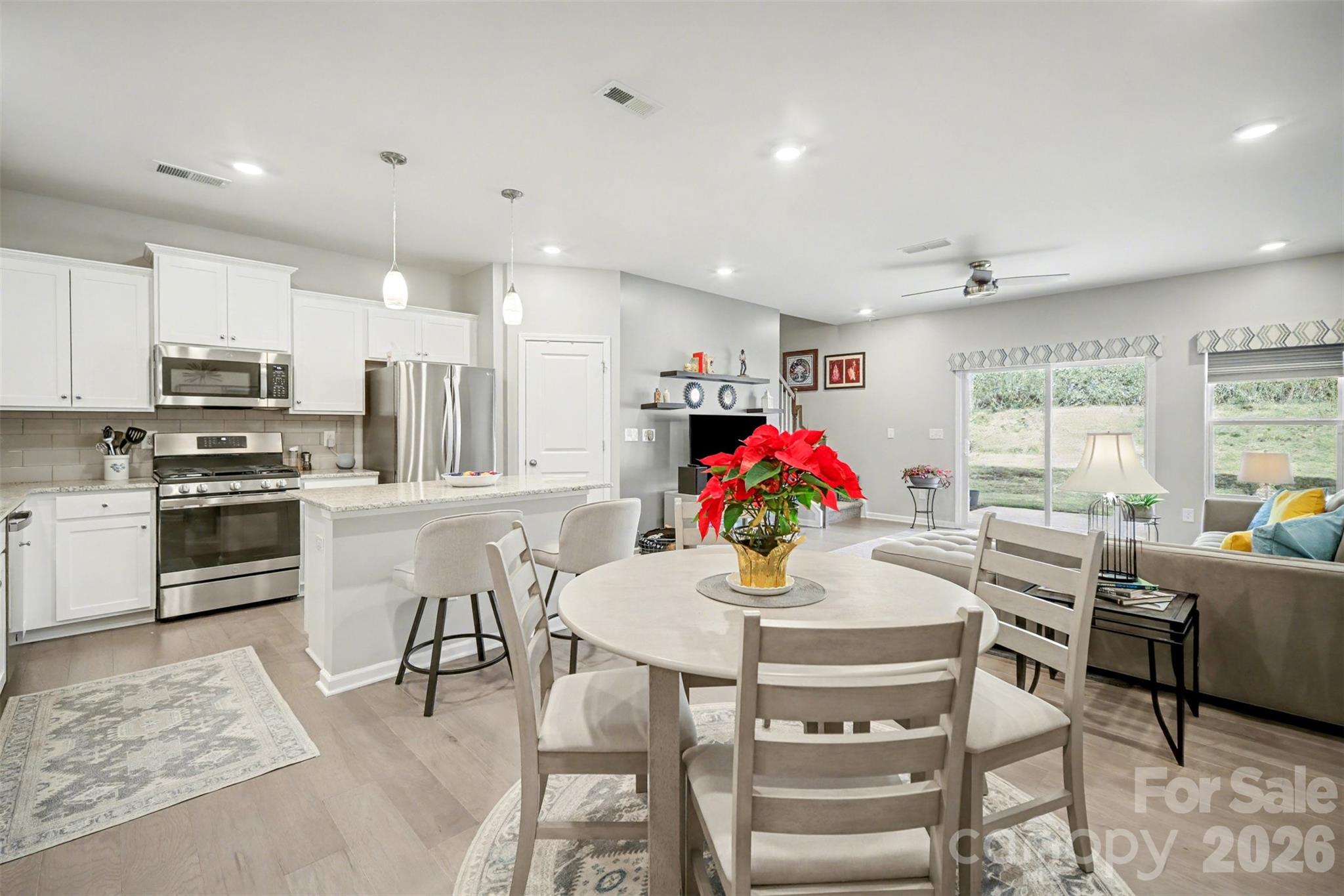 226 Quinn Road Matthews, NC 28104 - Photo 2 of 30 a kitchen with stainless steel appliances kitchen island granite countertop a sink and cabinets