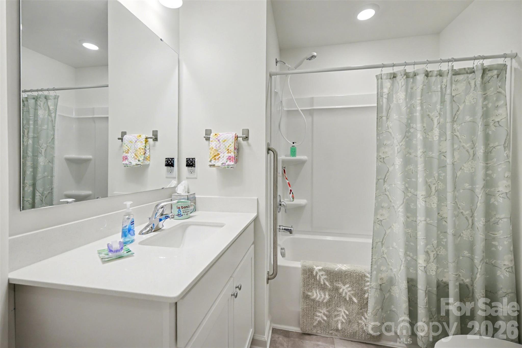 226 Quinn Road Matthews, NC 28104 - Photo 26 of 30 a bathroom with a sink a mirror a vanity and a shower