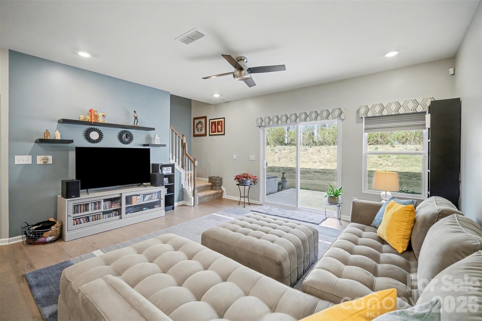 226 Quinn Road Matthews, NC 28104 - Photo 9 of 30 a living room with furniture and a flat screen tv