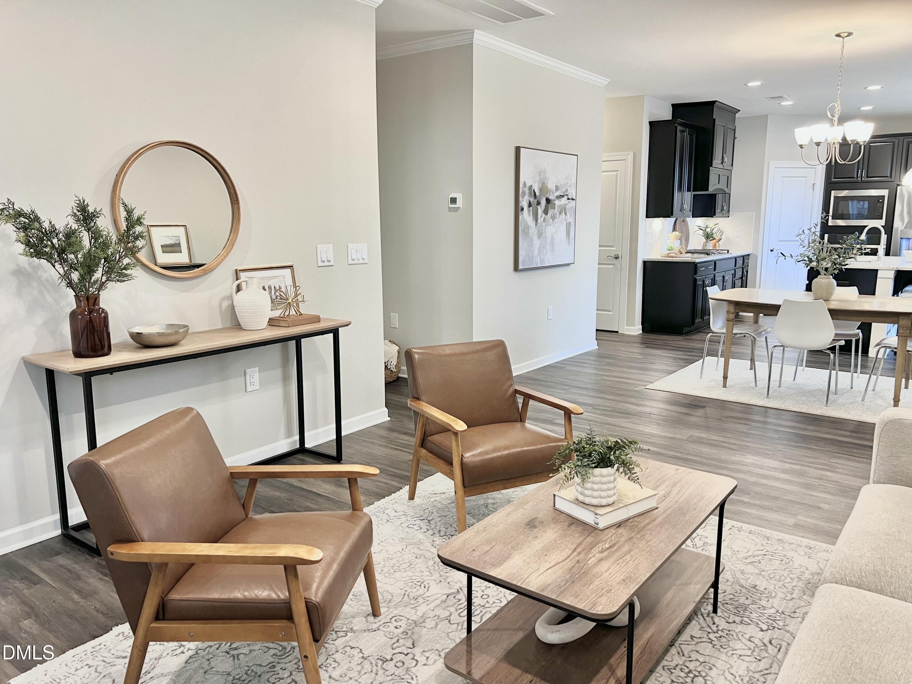 608 Atticus Way Durham, NC 27703 - Photo 12 of 30 a living room with furniture a rug and kitchen view