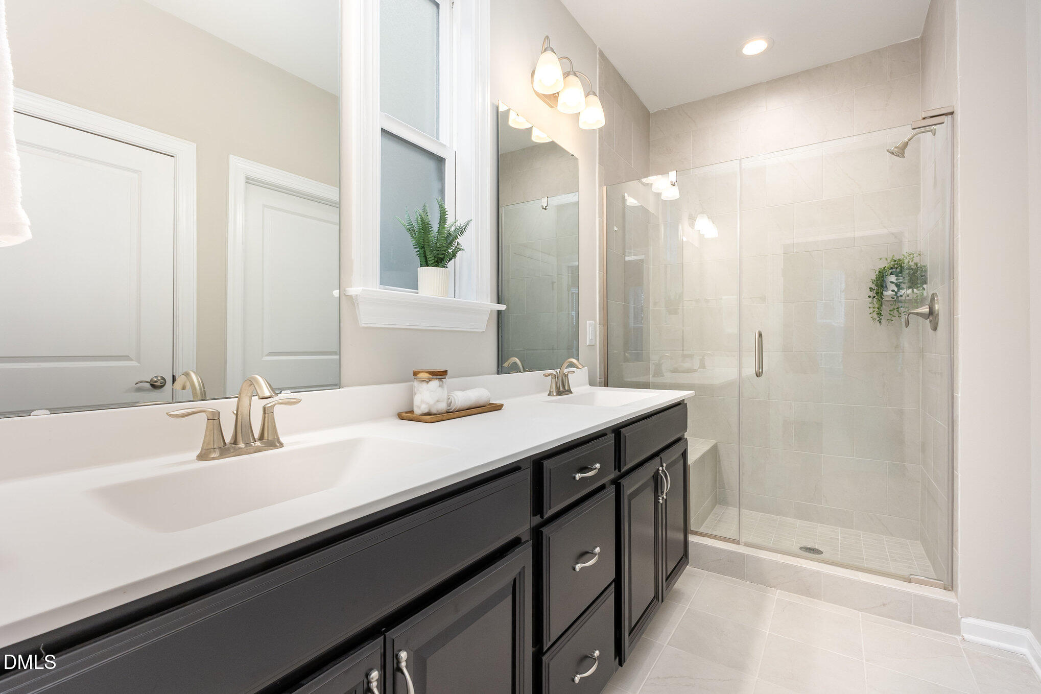 608 Atticus Way Durham, NC 27703 - Photo 15 of 31 a bathroom with a sink double vanity and a mirror
