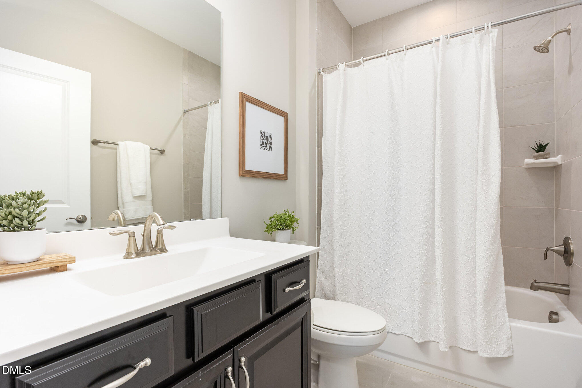 608 Atticus Way Durham, NC 27703 - Photo 14 of 30 a bathroom with a sink a toilet and shower curtain