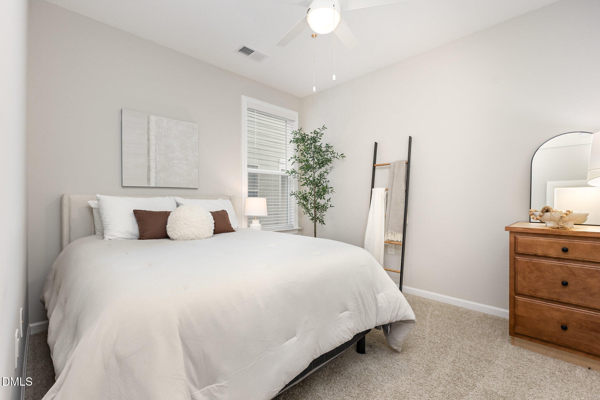 608 Atticus Way Durham, NC 27703 - Photo 15 of 31 a bedroom with a bed and a dresser