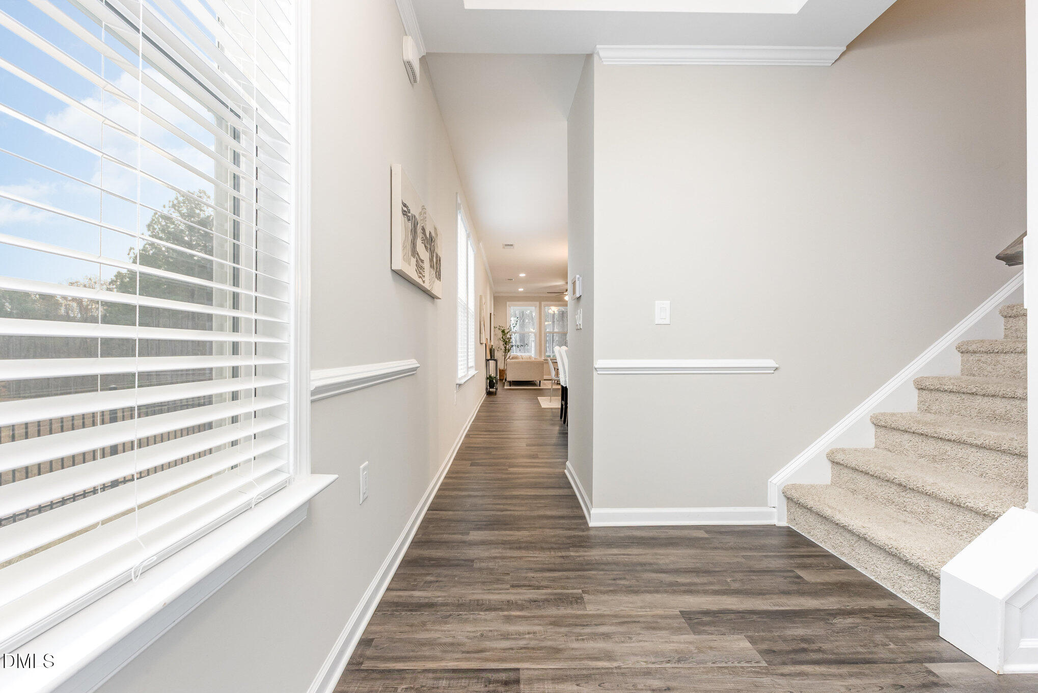 608 Atticus Way Durham, NC 27703 - Photo 18 of 31 a view of a hallway with wooden floor and staircase