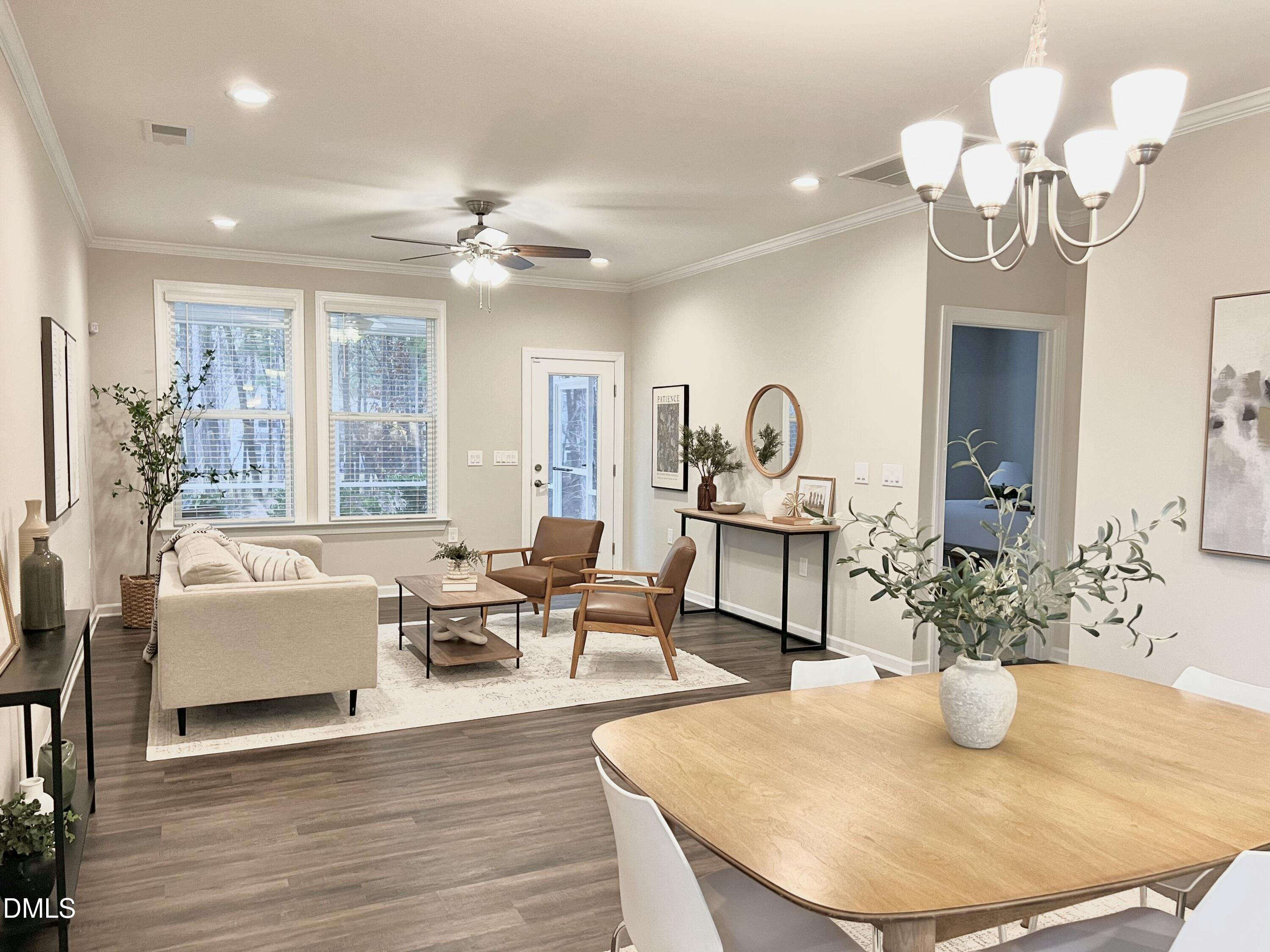 608 Atticus Way Durham, NC 27703 - Photo 30 of 31 a living room with dining table furniture and a chandelier