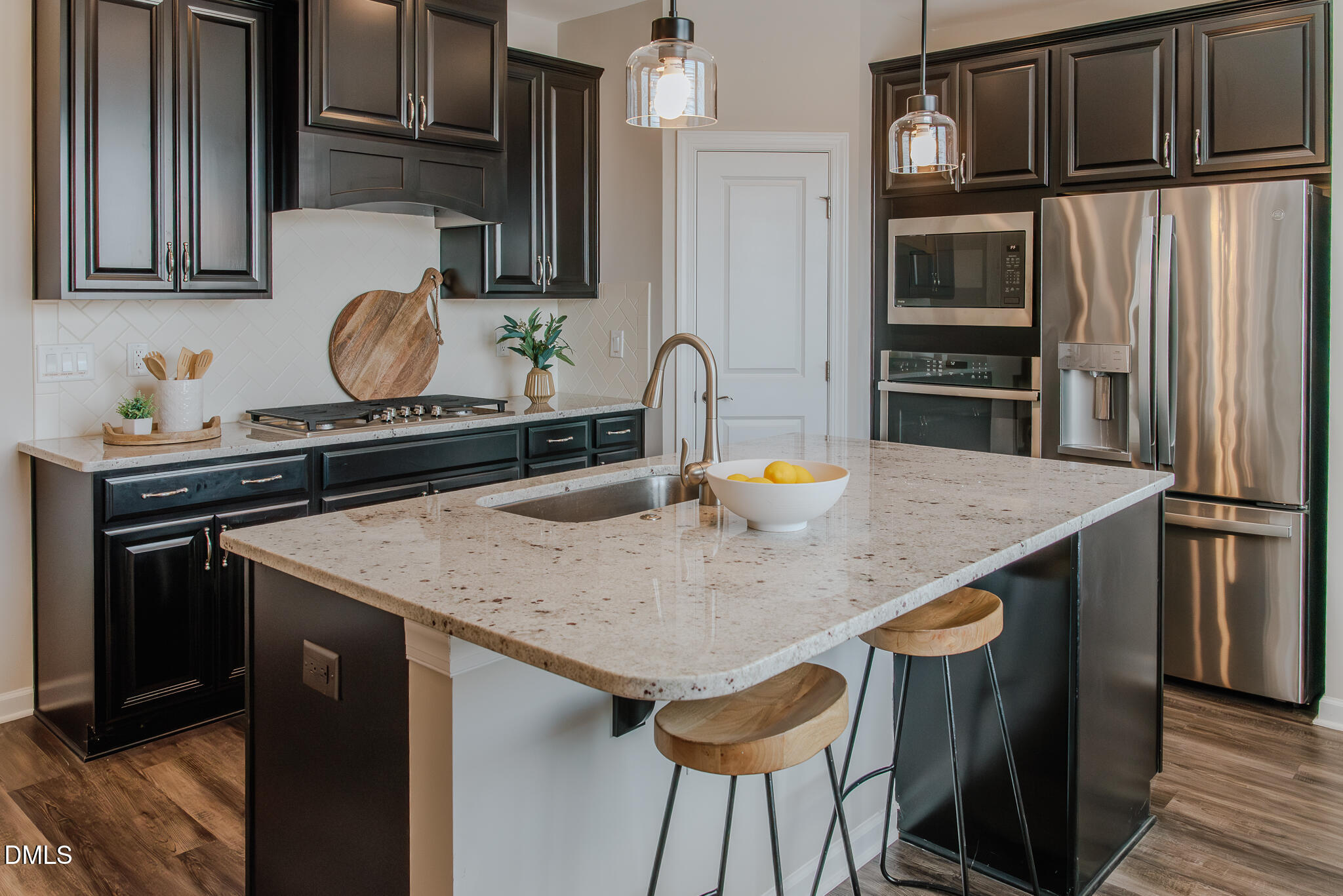 608 Atticus Way Durham, NC 27703 - Photo 4 of 31 a kitchen with stainless steel appliances a kitchen island a stove a table and chairs