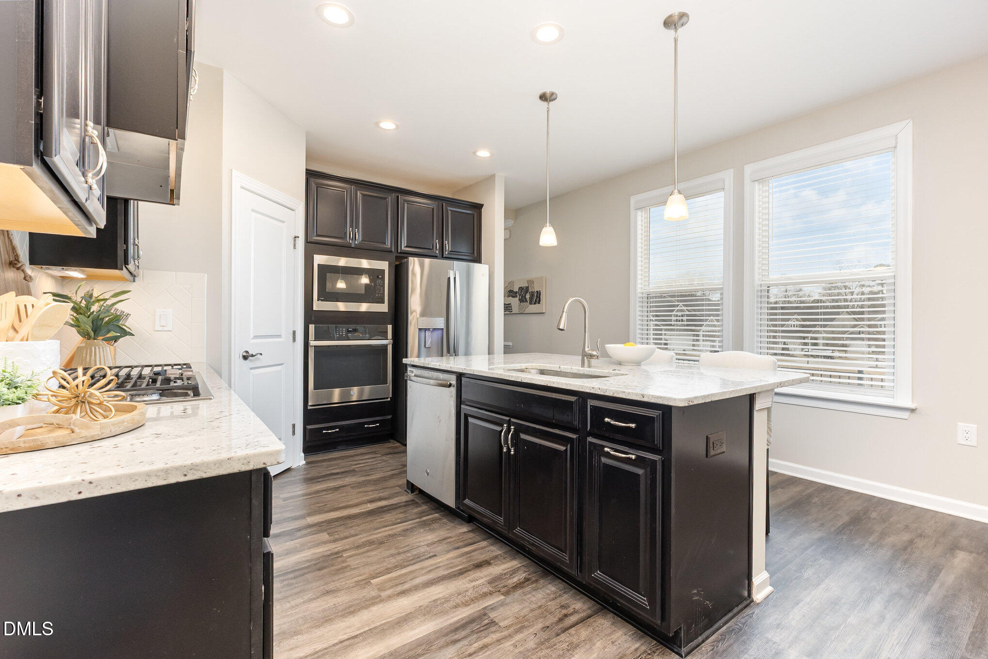 608 Atticus Way Durham, NC 27703 - Photo 5 of 30 a kitchen with stainless steel appliances granite countertop a sink stove and refrigerator