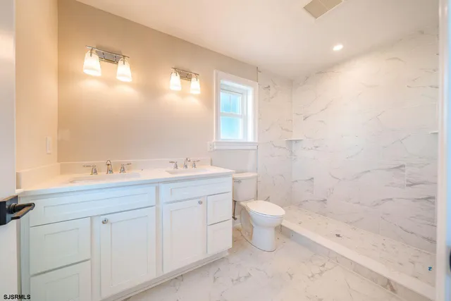 a bathroom with a toilet a sink and bathtub