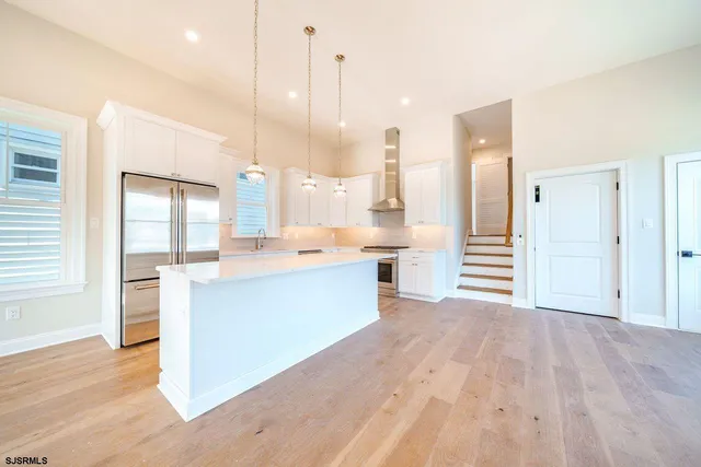 a large white kitchen with a large window