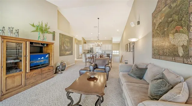 a kitchen with a sink stools a counter space and cabinets