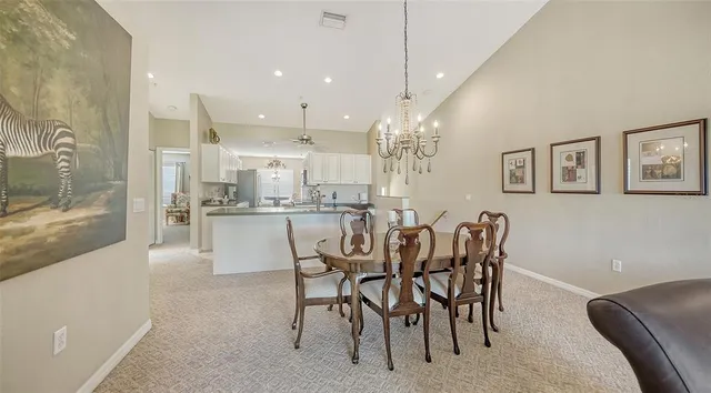 a large kitchen with granite countertop a large counter top stainless steel appliances and cabinets