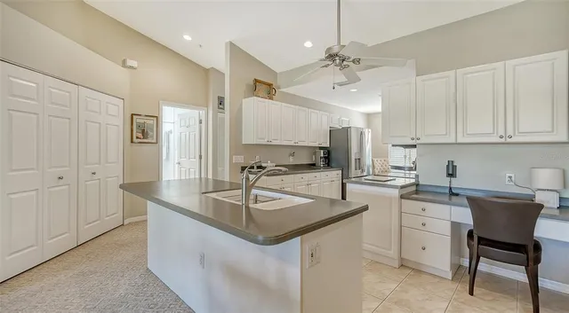 a kitchen with stainless steel appliances granite countertop a stove a sink a microwave and a refrigerator