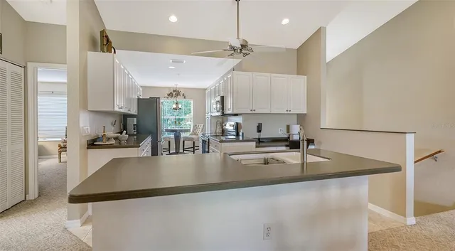 a kitchen with stainless steel appliances granite countertop a refrigerator sink and cabinets