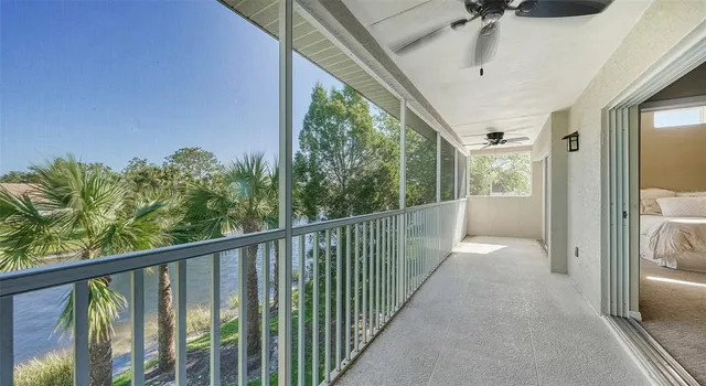 a living room with furniture a flat screen tv and a large window