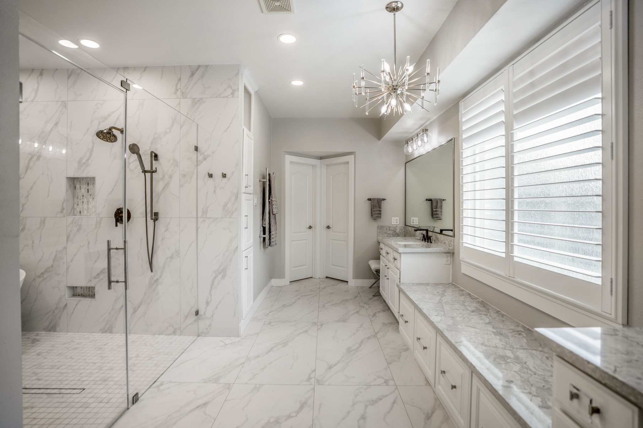 9707 Blue Cruls Way Spring, TX 77379 - Photo 29 of 50 a bathroom with a granite countertop sink a large mirror and a bathtub
