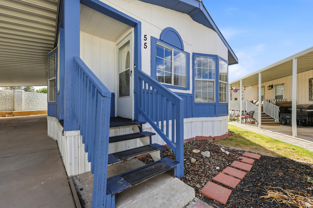 150 West 7500th South, Unit 55 Midvale, UT 84047 - Photo 5 of 28 Exterior featuring a white facade with blue trim and an arched accent