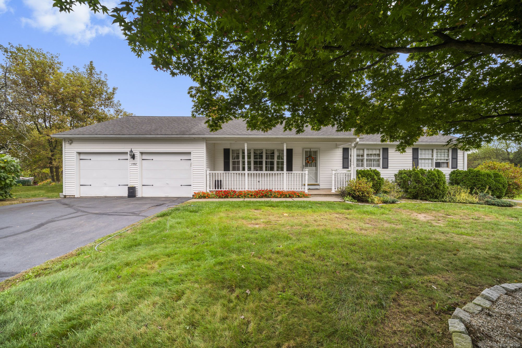 a front view of a house with a garden