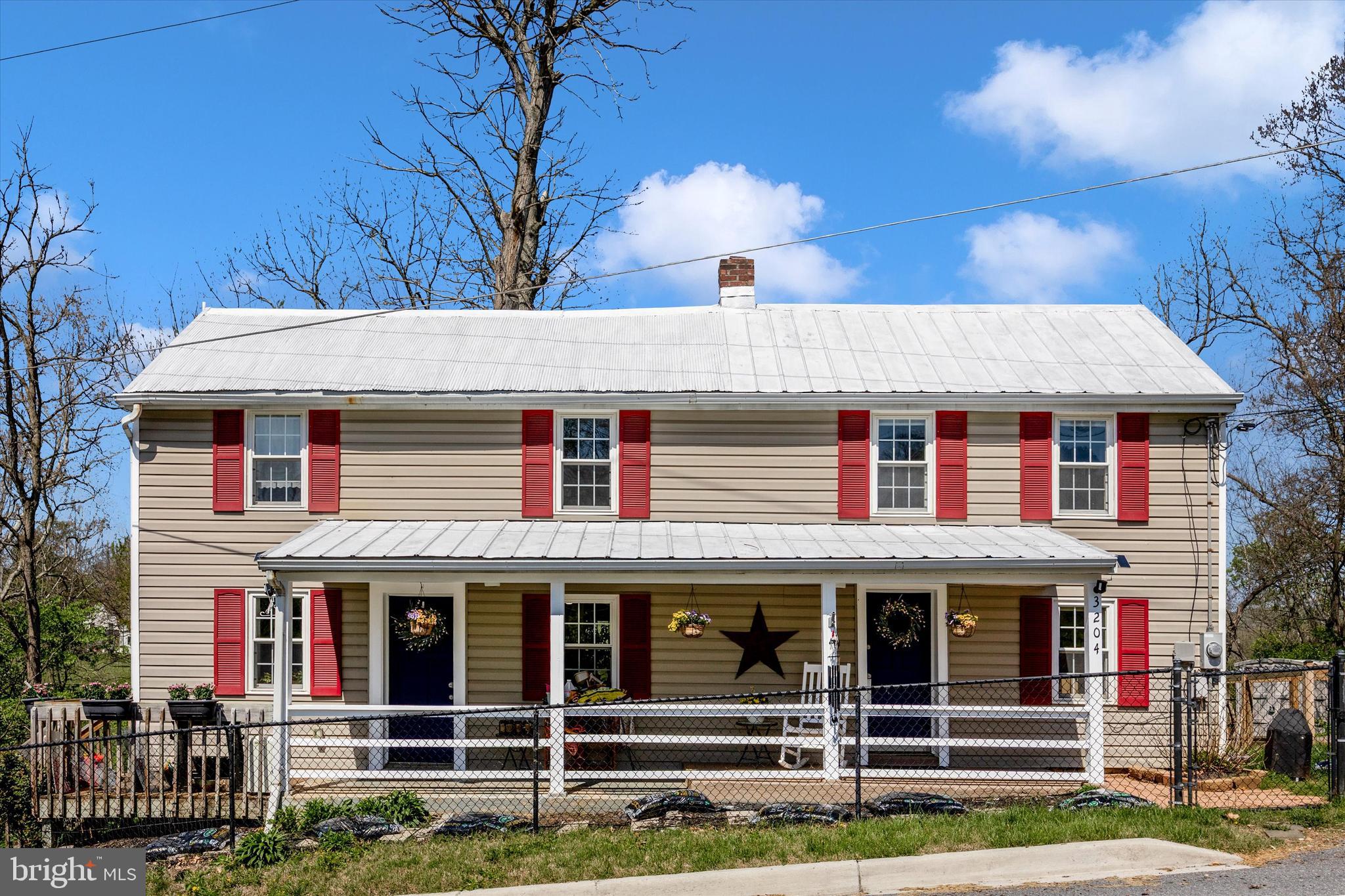 3204 Bidle Road Middletown, MD 21769 - Photo 1 of 23 a view of a white house with large windows and a small yard