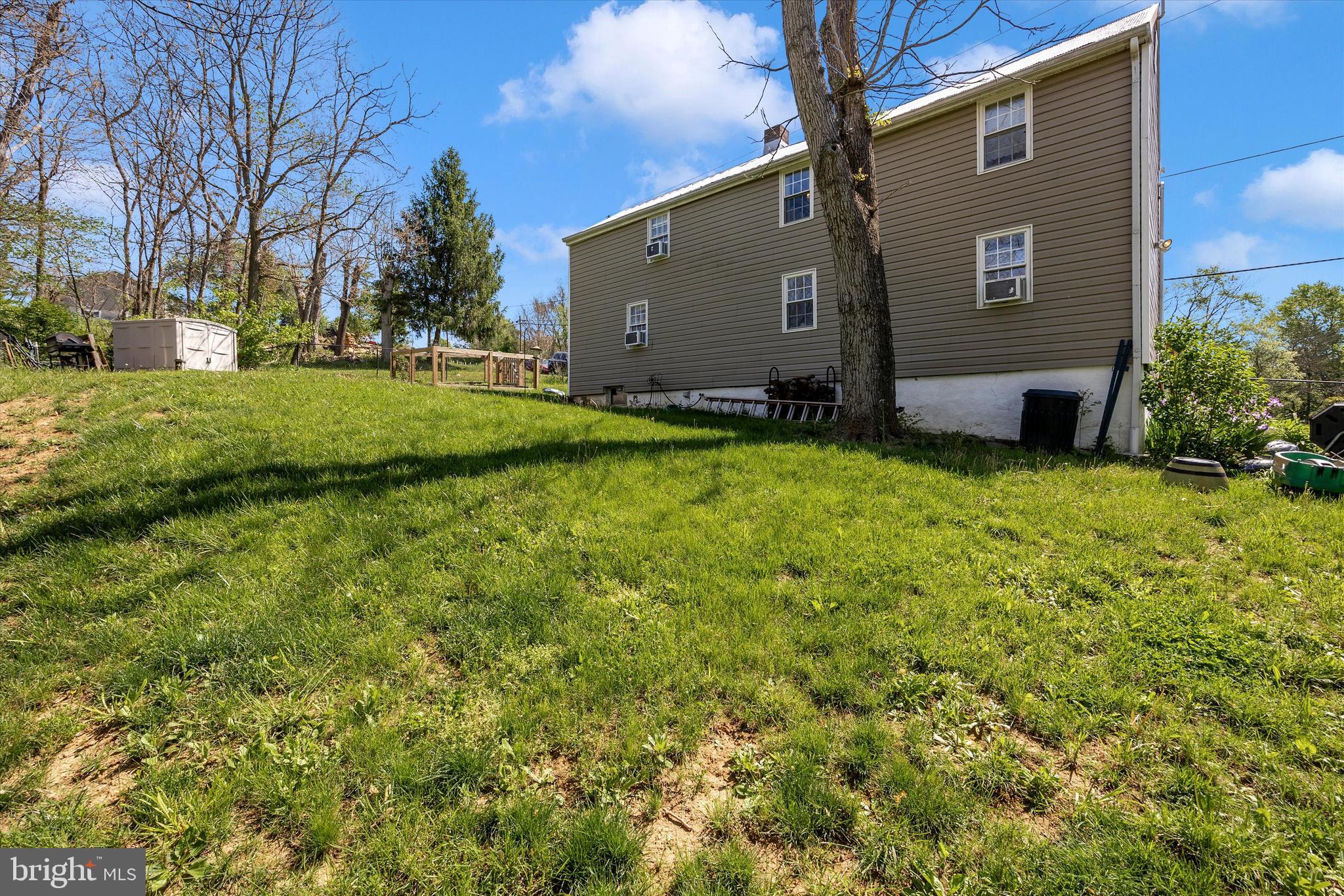3204 Bidle Road Middletown, MD 21769 - Photo 16 of 23 a backyard of a house with large trees and plants