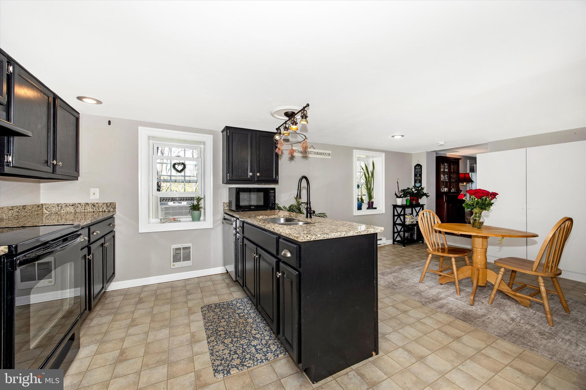 3204 Bidle Road Middletown, MD 21769 - Photo 5 of 23 a kitchen with a stove top oven and cabinets
