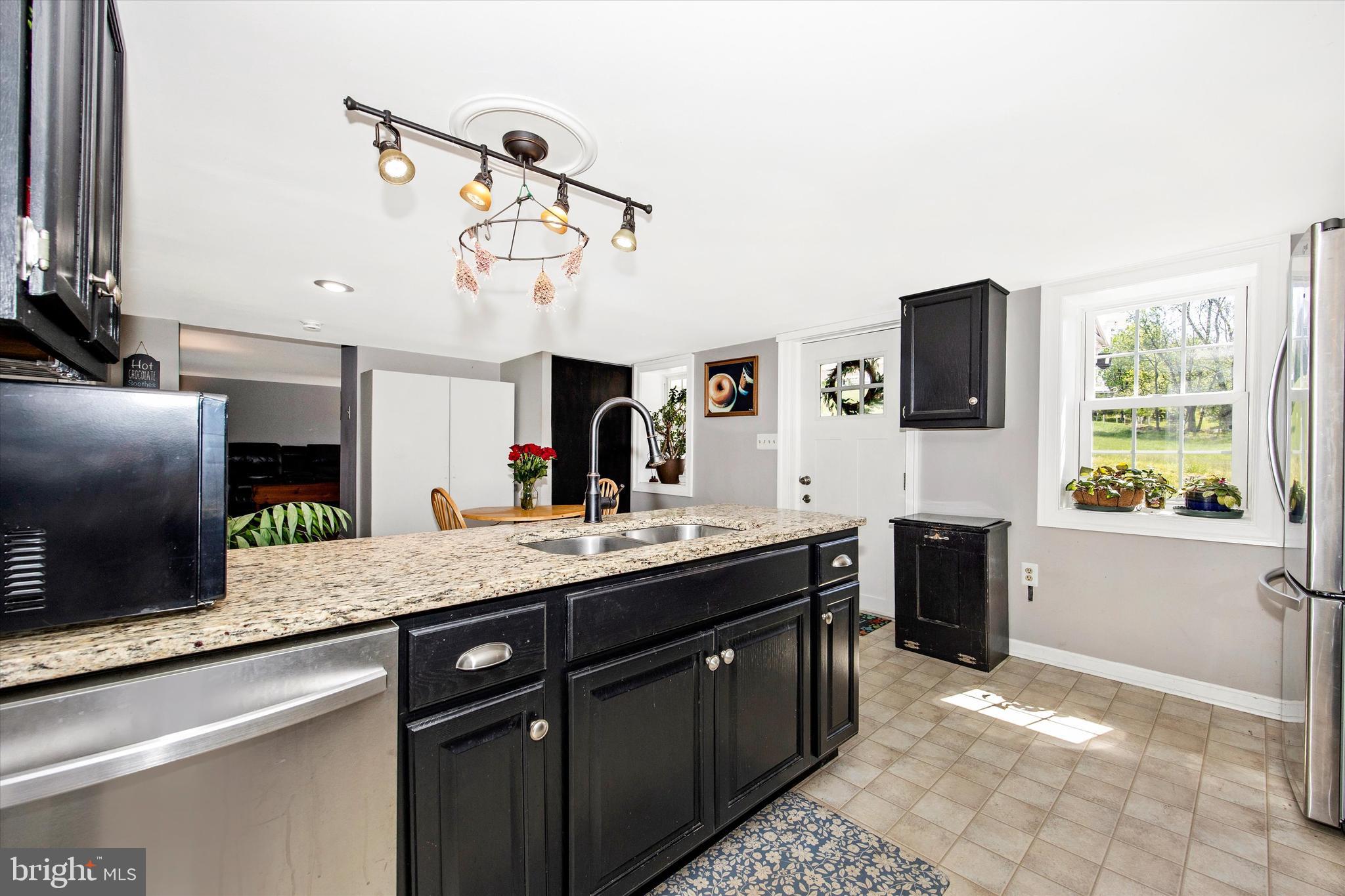 3204 Bidle Road Middletown, MD 21769 - Photo 7 of 23 a kitchen with stainless steel appliances kitchen island granite countertop a sink and a stove