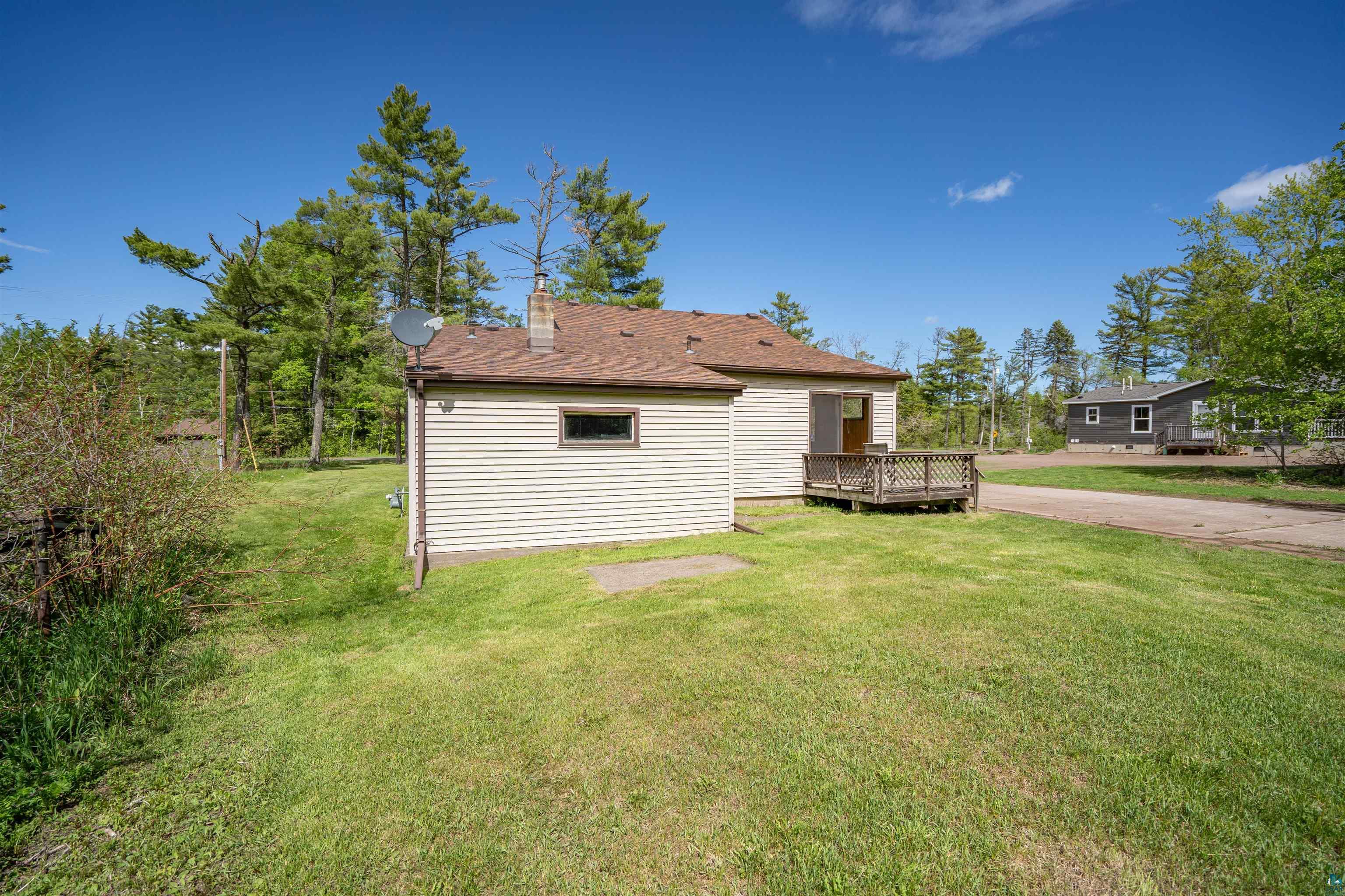 3469 County Road East South Range, WI 54874 - Photo 15 of 19 Exterior space featuring a deck and a lawn