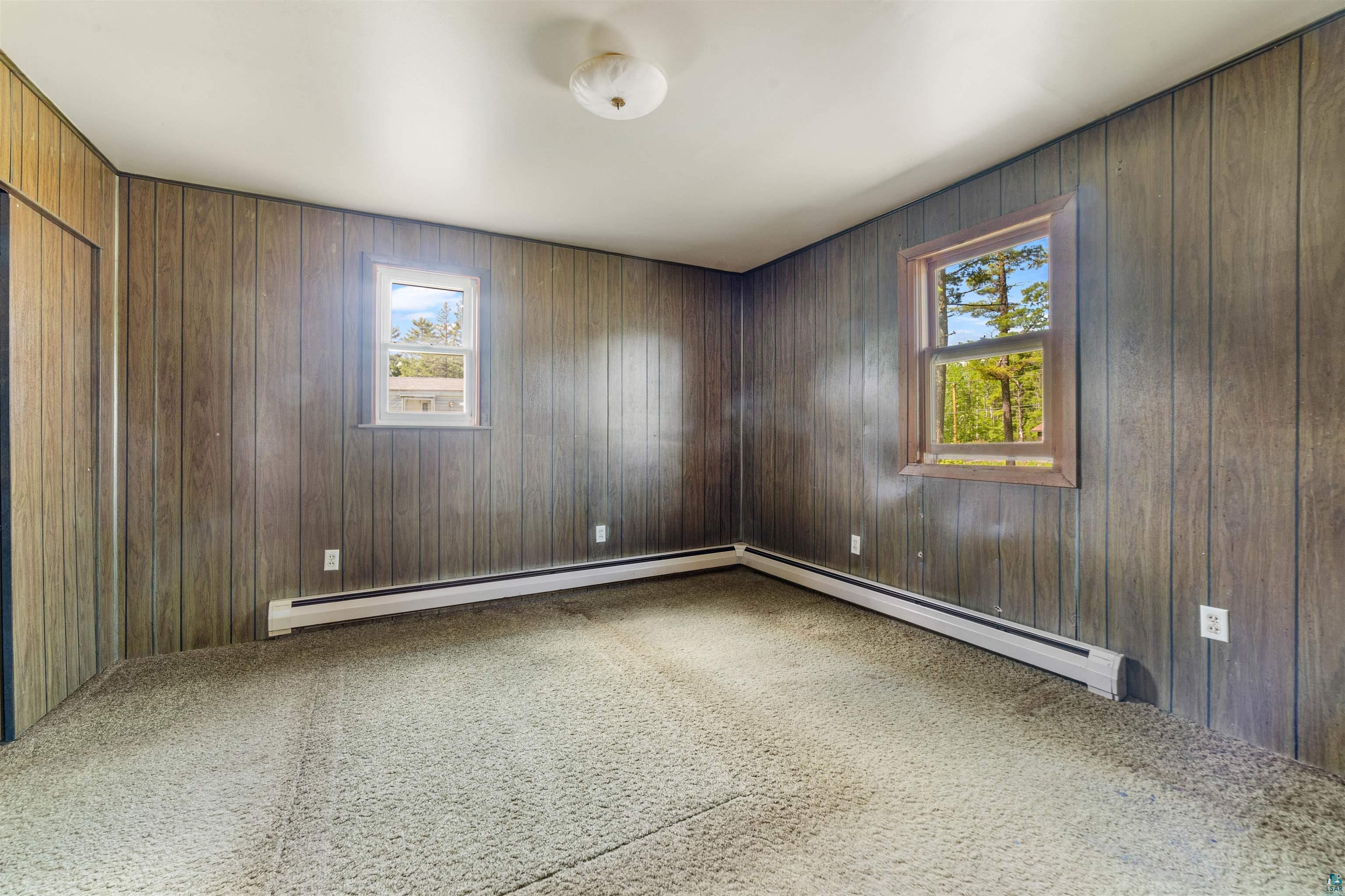 3469 County Road East South Range, WI 54874 - Photo 7 of 19 Carpeted empty room featuring wood walls