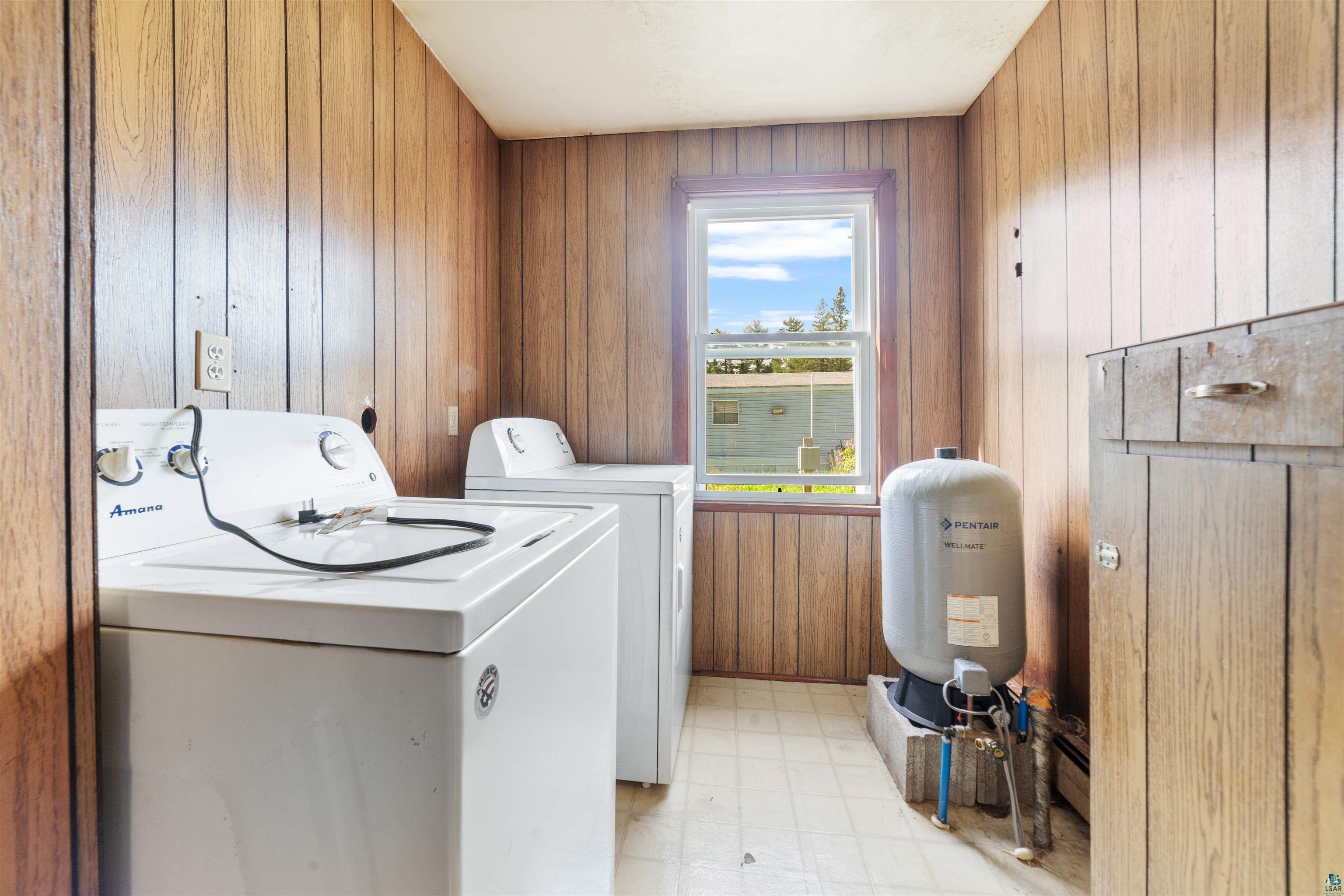 3469 County Road East South Range, WI 54874 - Photo 9 of 19 Laundry room with separate washer and dryer, wooden walls, and light tile floors