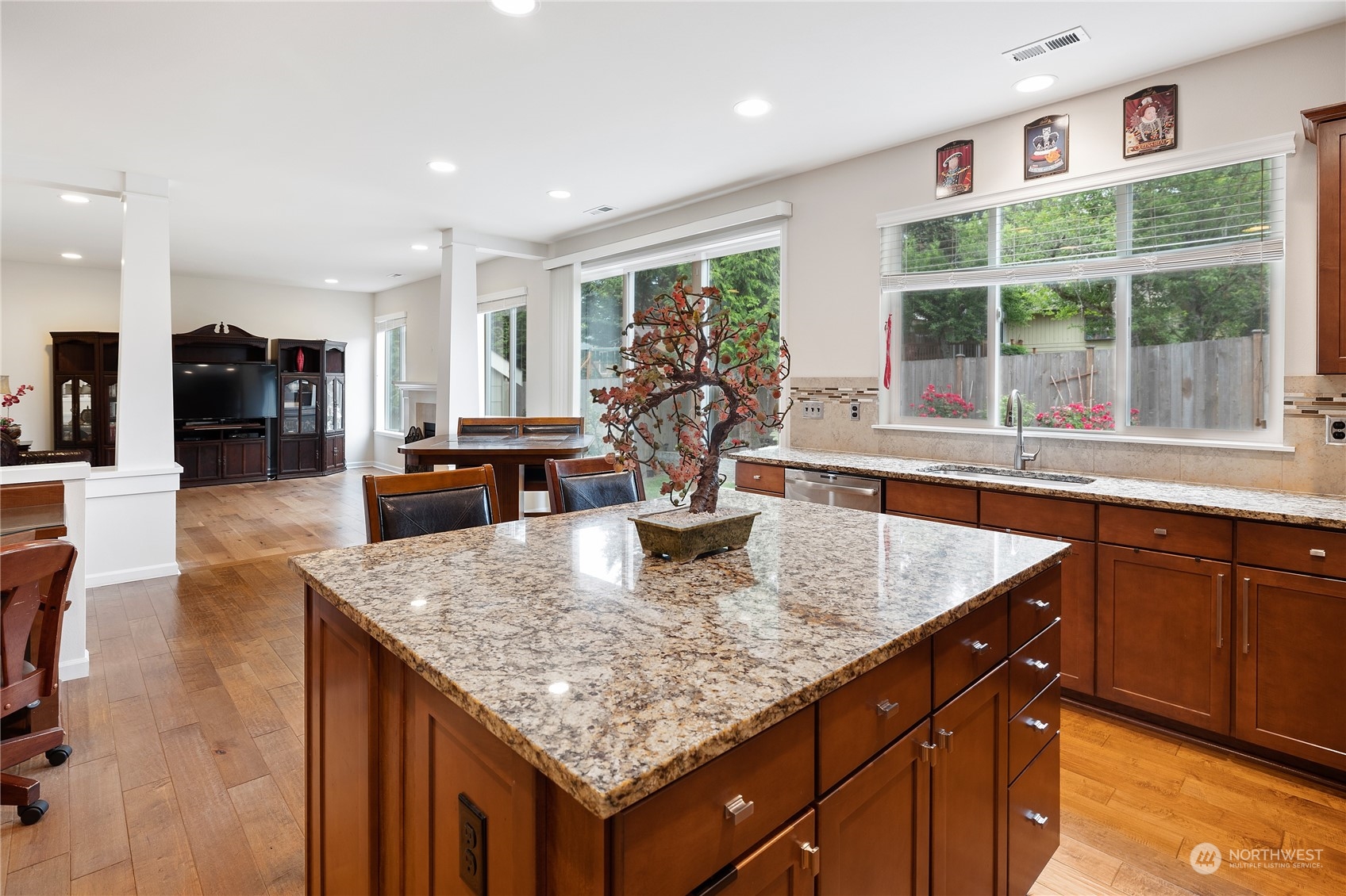16224 Southeast 138th Place Renton, WA 98059 - Photo 17 of 40 a kitchen with stainless steel appliances granite countertop sink stove and wooden floor