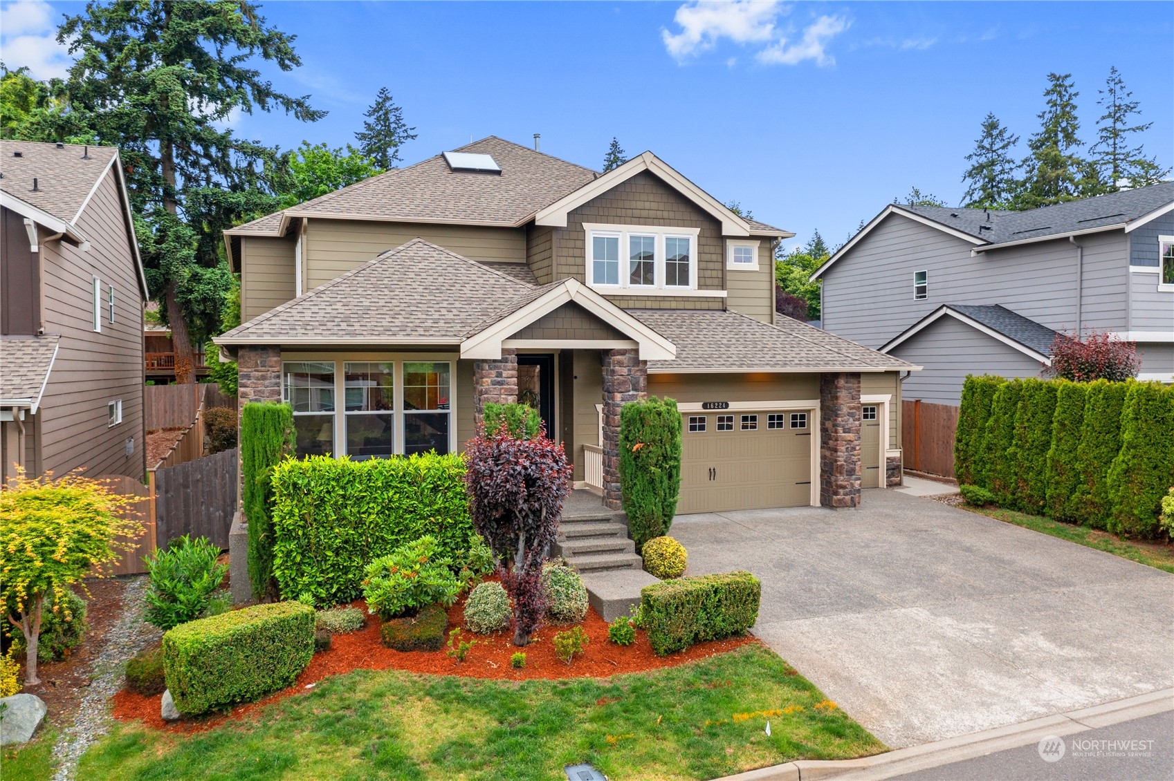 16224 Southeast 138th Place Renton, WA 98059 - Photo 2 of 40 a front view of a house with a yard and potted plants