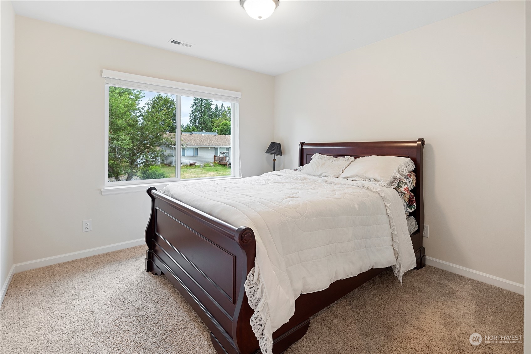 16224 Southeast 138th Place Renton, WA 98059 - Photo 23 of 40 a bed sitting in a bedroom next to a window