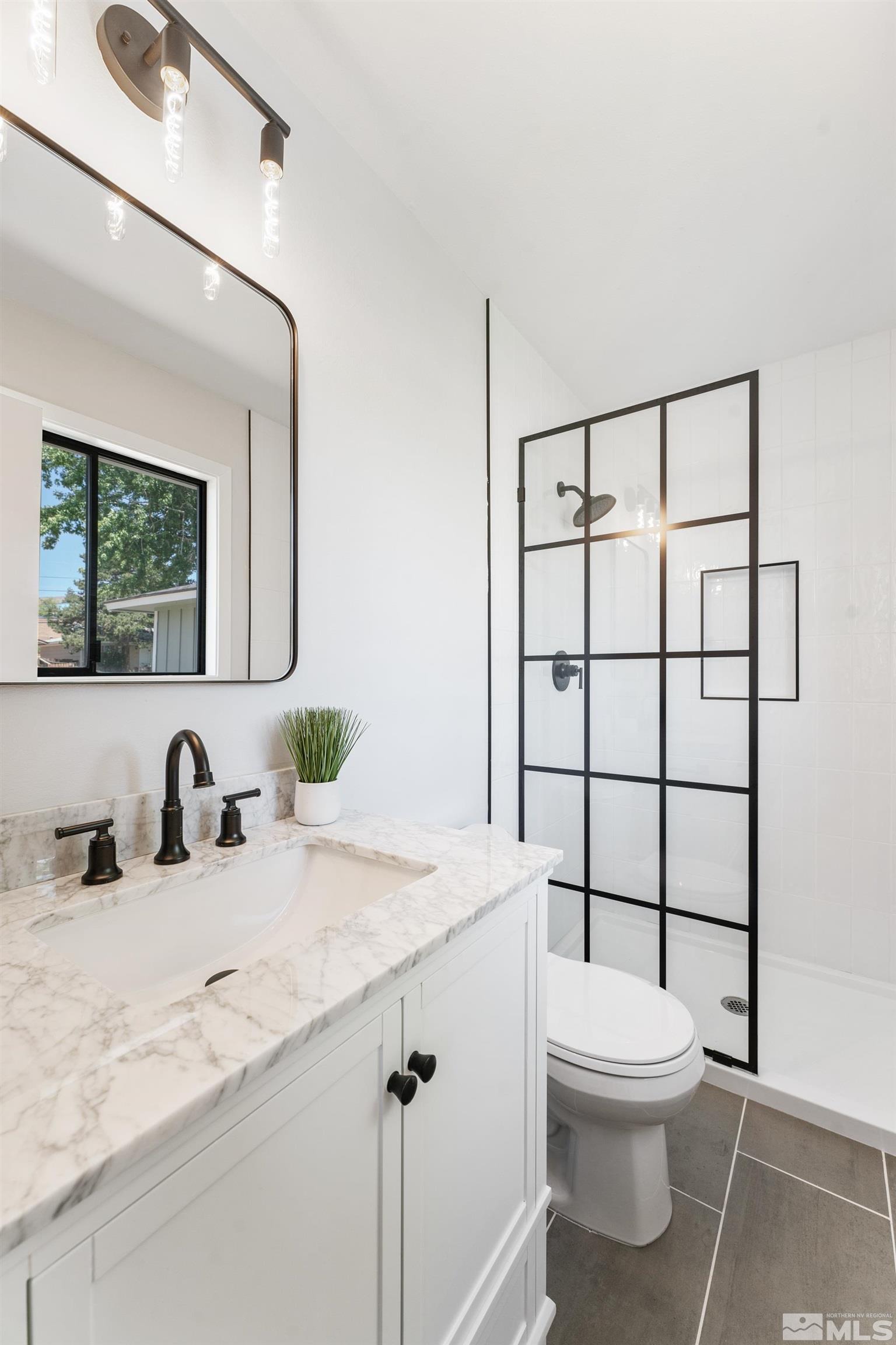 3380 Bryan Street Reno, NV 89503 - Photo 11 of 40 a bathroom with a sink a toilet and shower