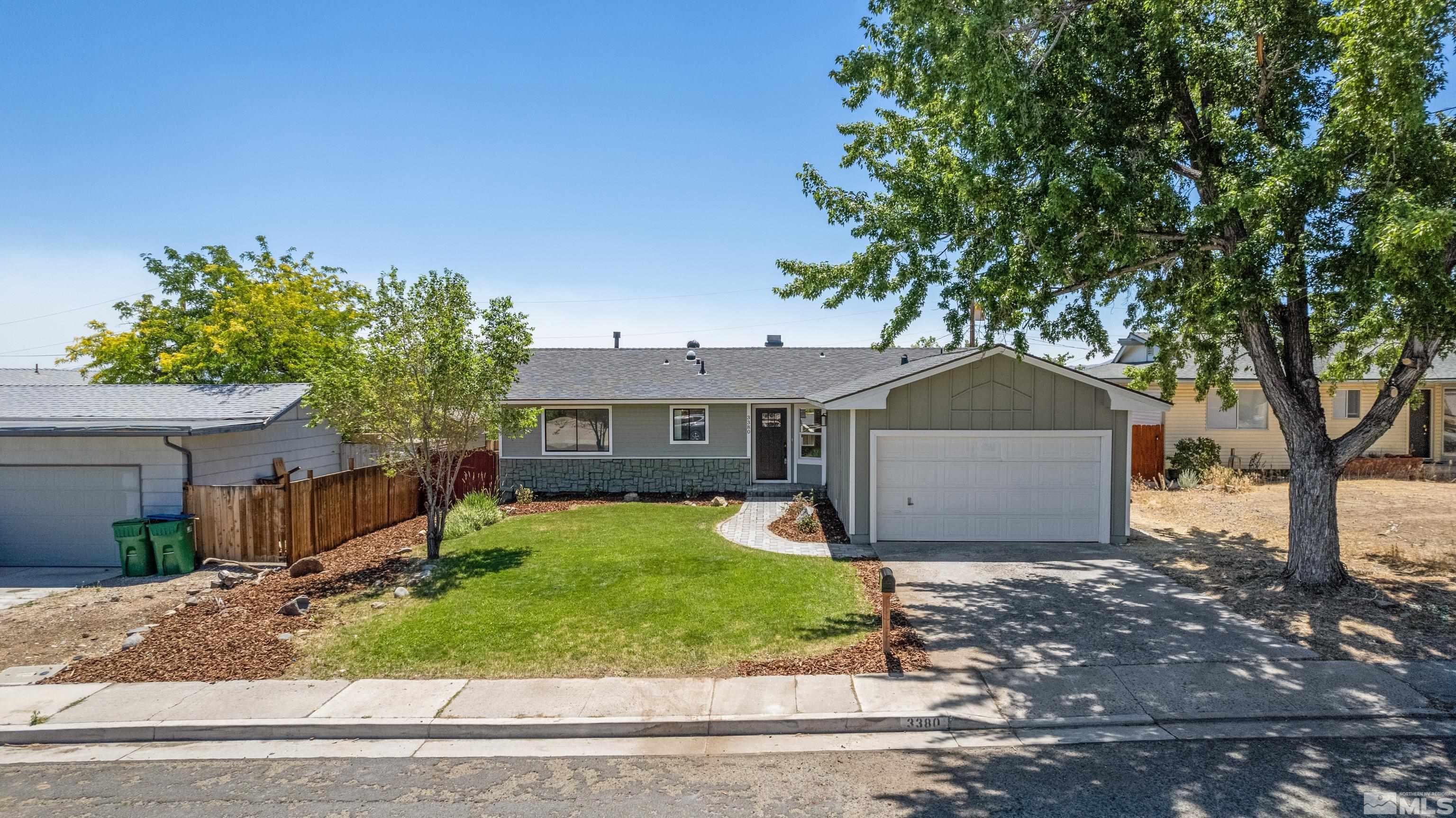 3380 Bryan Street Reno, NV 89503 - Photo 13 of 40 a front view of a house with a yard and garage