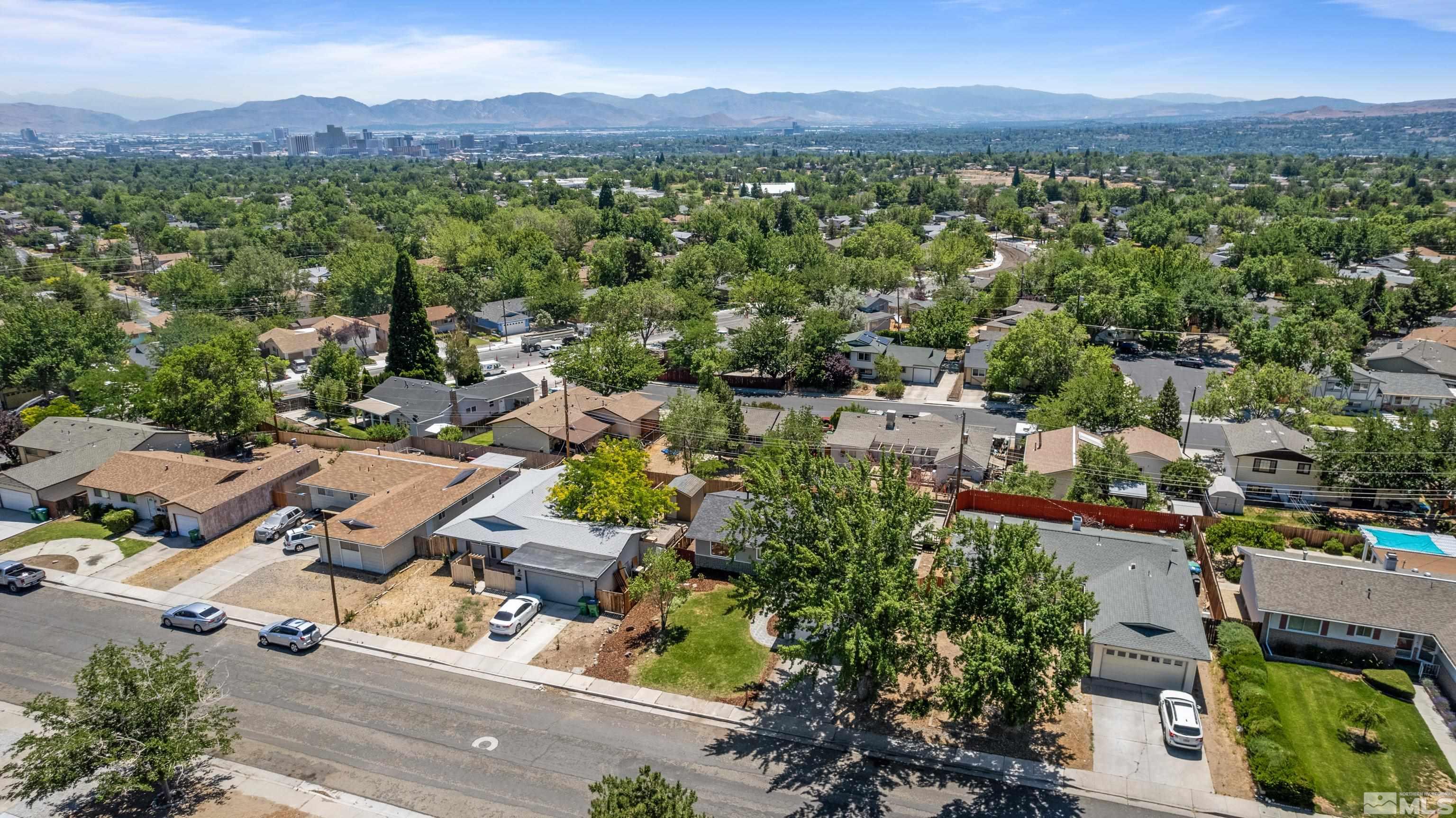 3380 Bryan Street Reno, NV 89503 - Photo 16 of 40 an aerial view of a city with lots of residential buildings and mountain view in back
