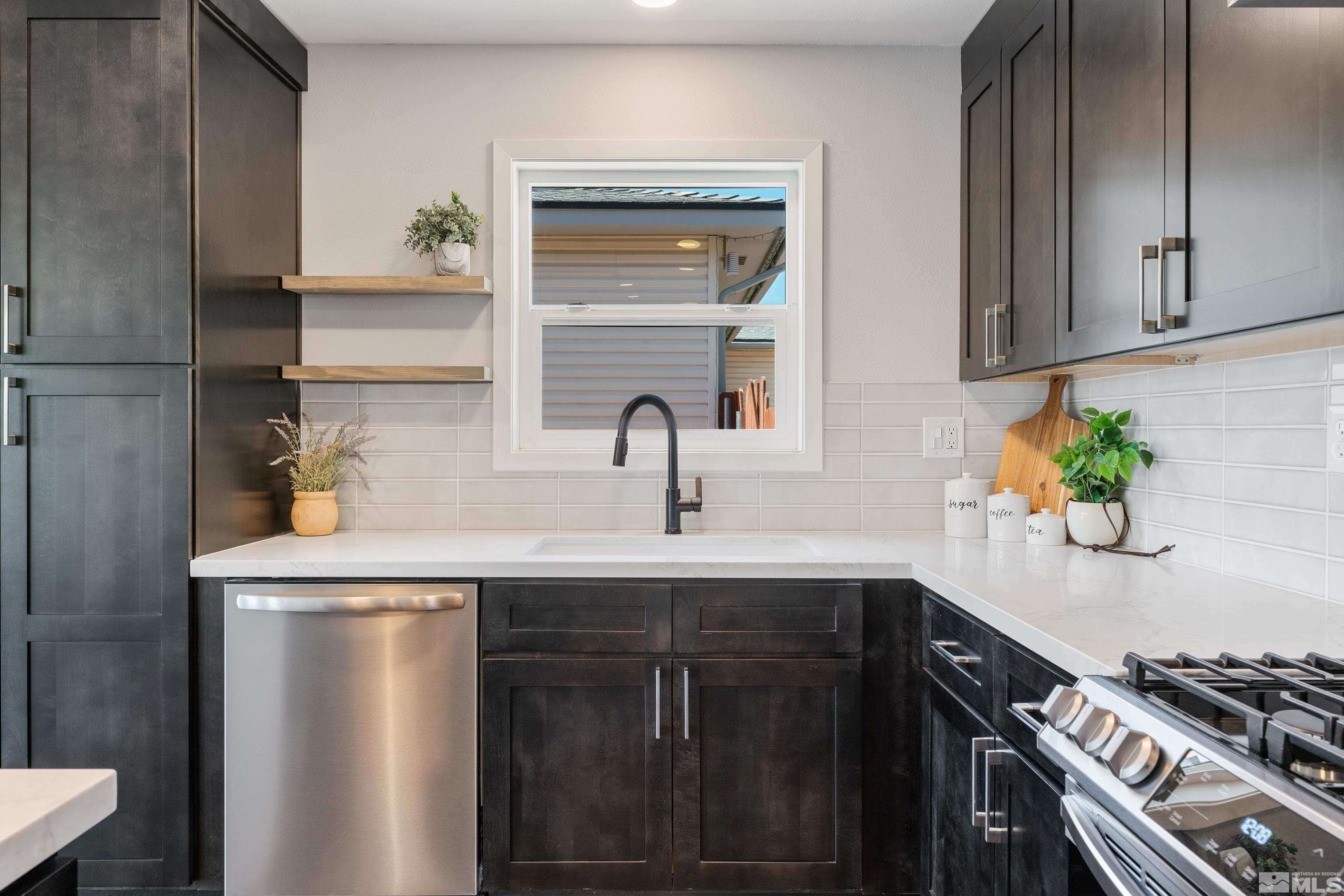 3380 Bryan Street Reno, NV 89503 - Photo 20 of 40 a kitchen with stainless steel appliances a sink a stove and cabinets