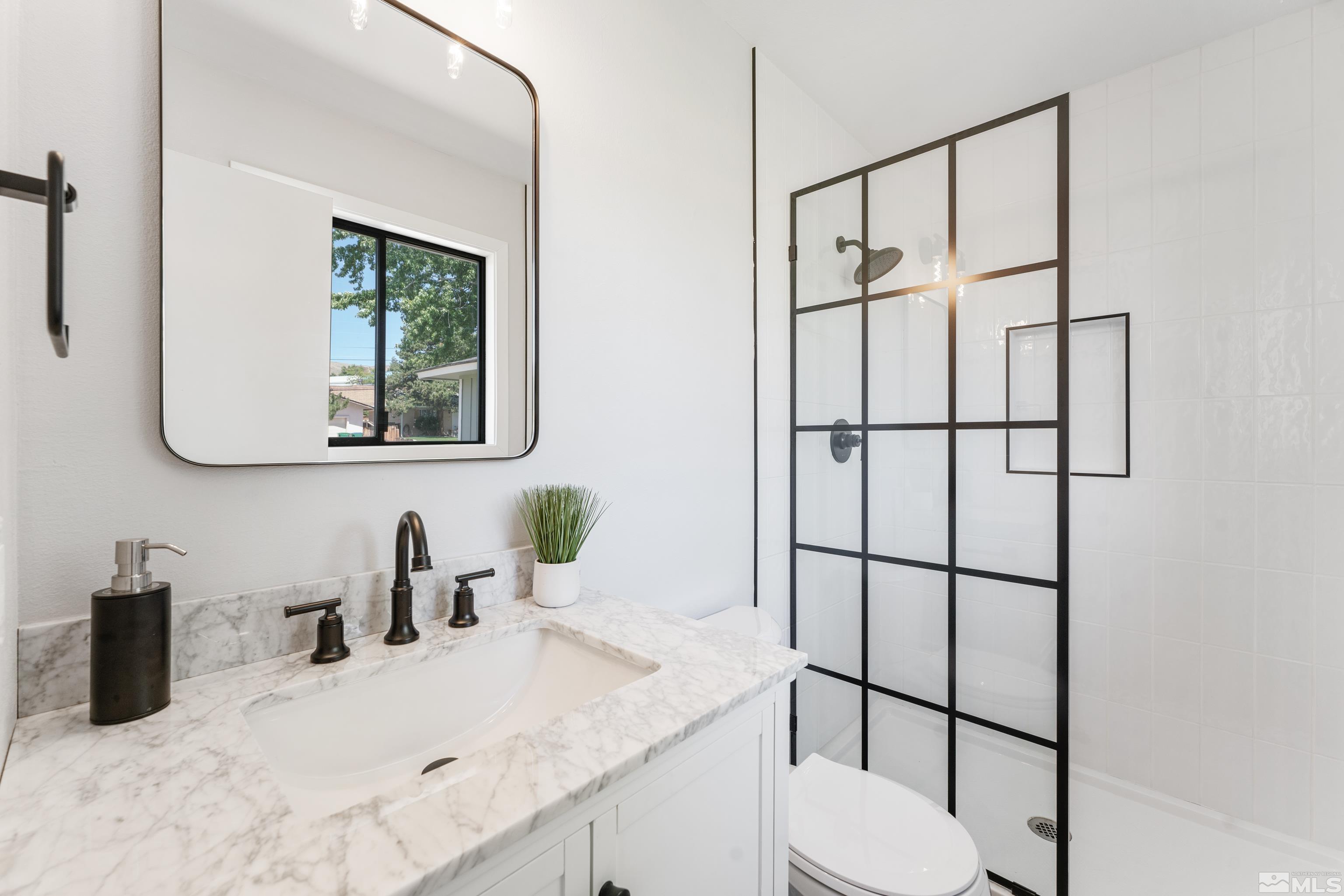 3380 Bryan Street Reno, NV 89503 - Photo 24 of 40 a bathroom with a sink toilet and mirror