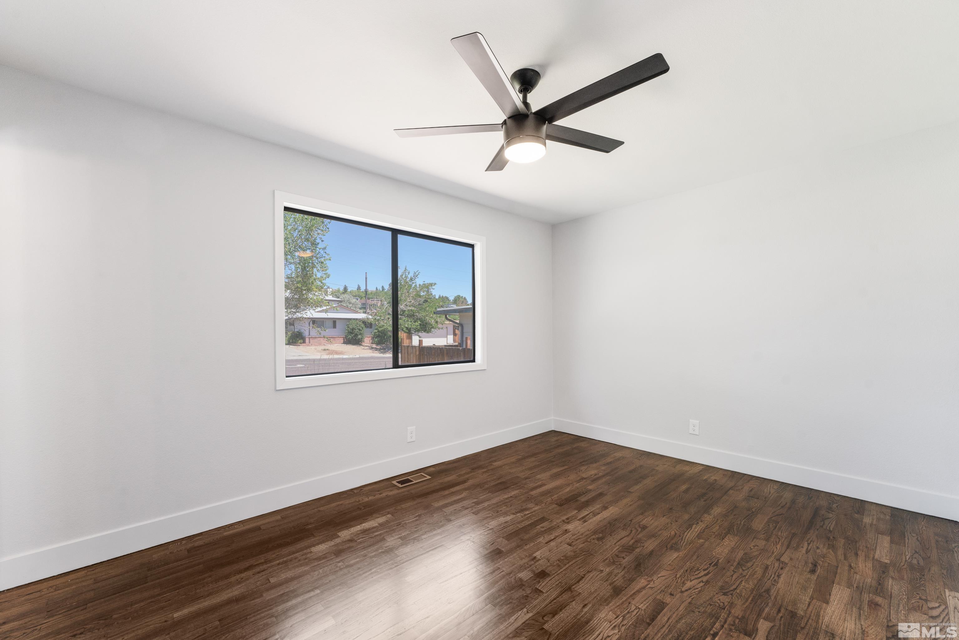 3380 Bryan Street Reno, NV 89503 - Photo 32 of 40 an empty room with wooden floor and windows