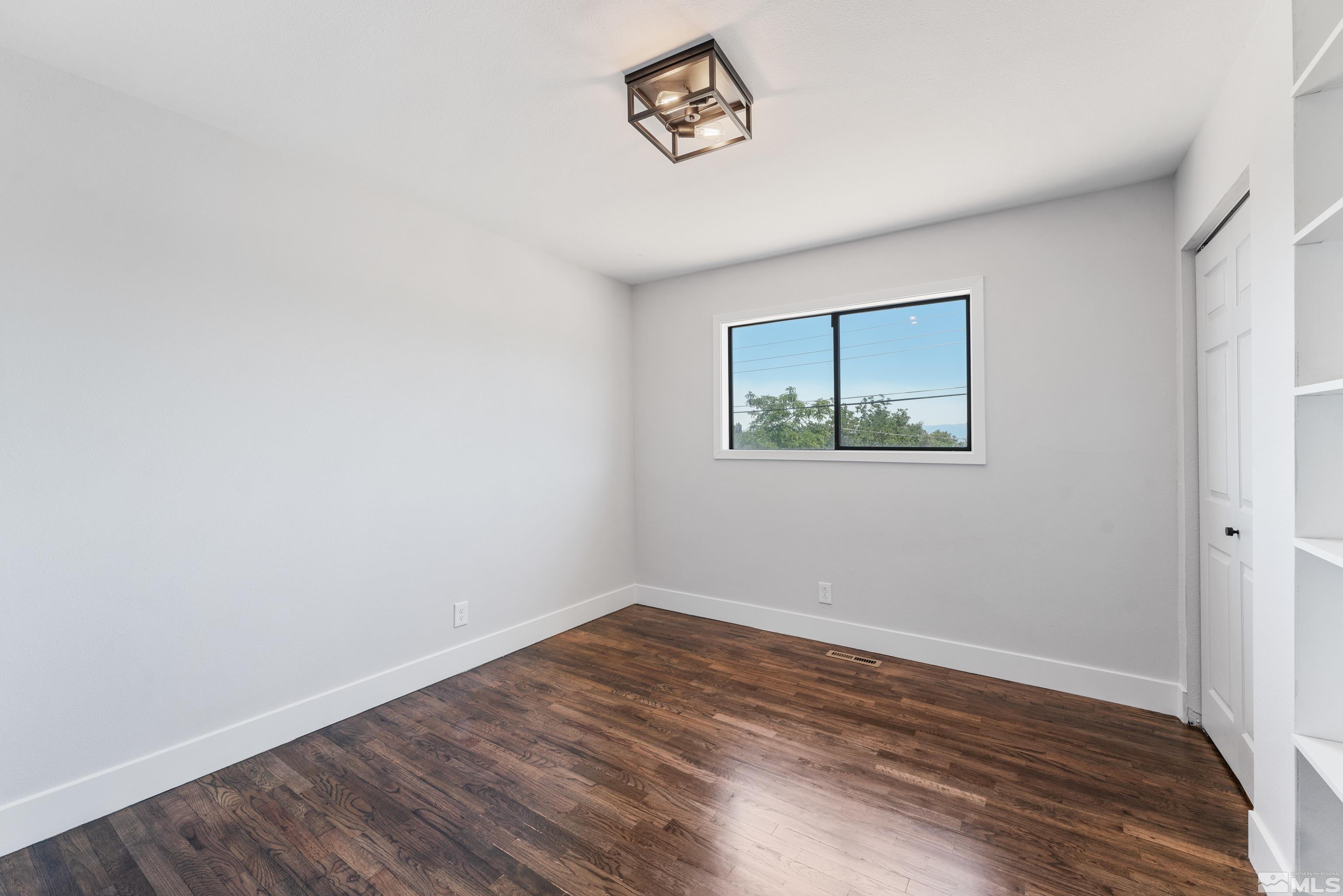 3380 Bryan Street Reno, NV 89503 - Photo 36 of 40 an empty room with wooden floor and a window