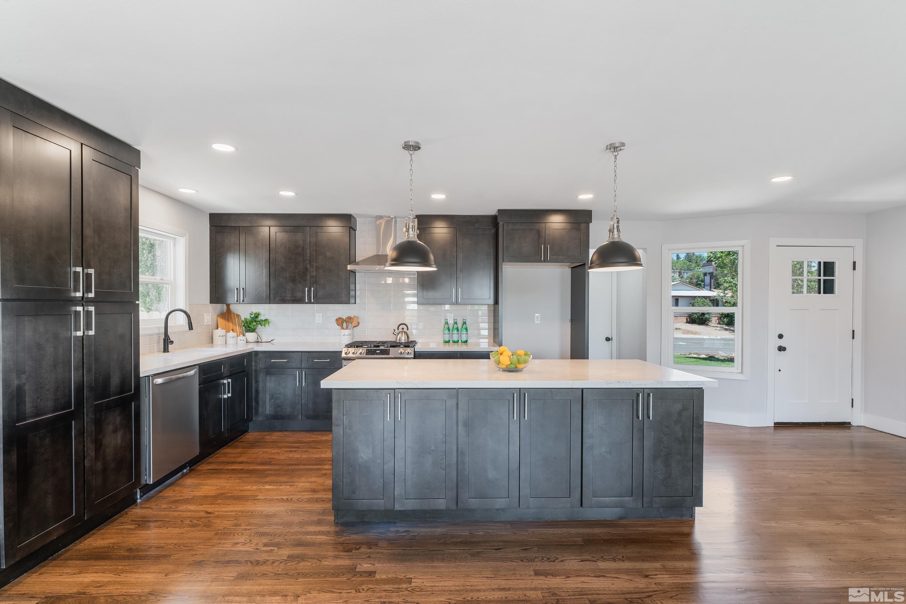 3380 Bryan Street Reno, NV 89503 - Photo 4 of 40 a large kitchen with stainless steel appliances kitchen island granite countertop a large counter top stainless steel appliances and cabinets