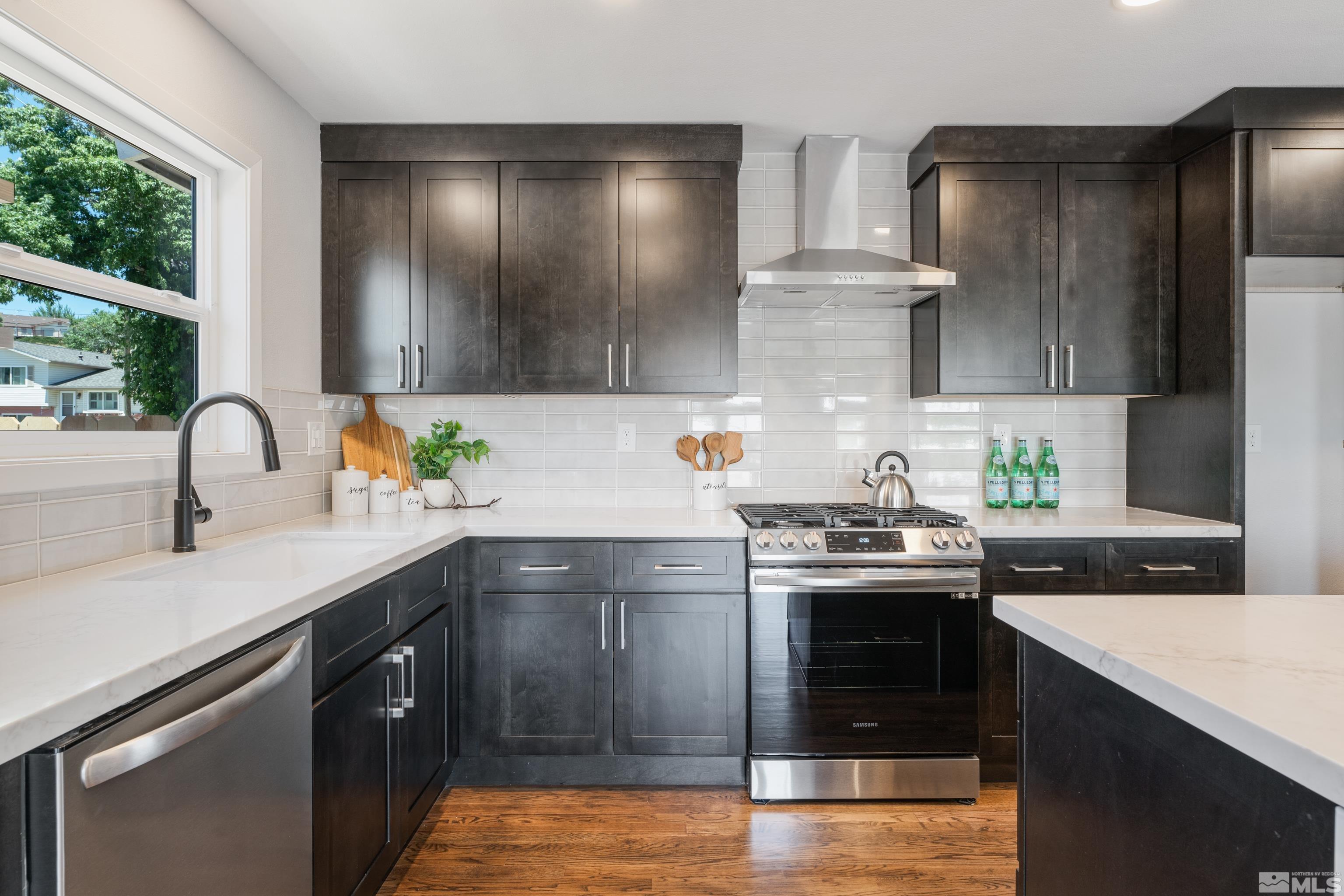 3380 Bryan Street Reno, NV 89503 - Photo 5 of 40 a kitchen with stainless steel appliances granite countertop a sink stove and cabinets