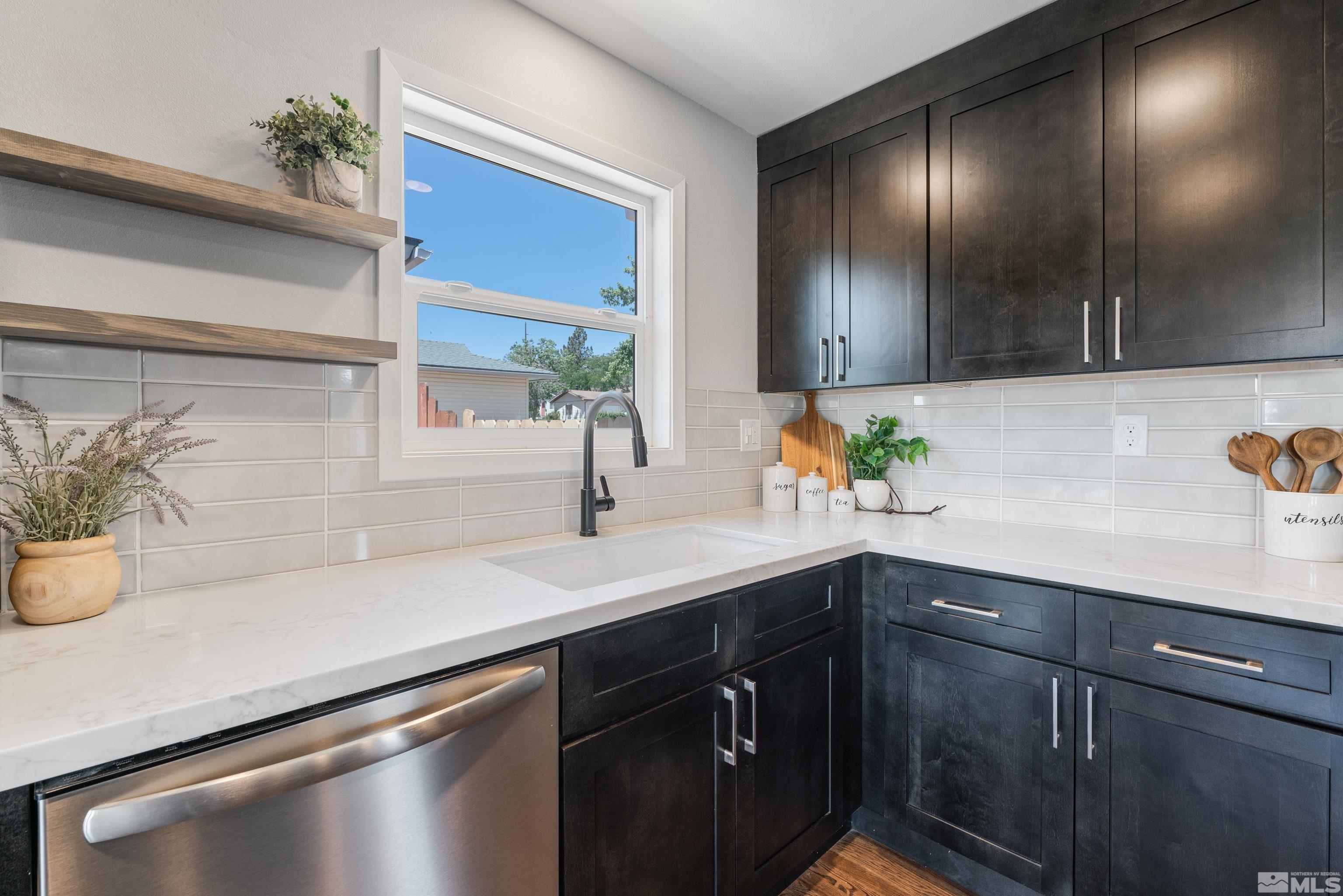 3380 Bryan Street Reno, NV 89503 - Photo 6 of 40 a kitchen with a sink a potted plant and cabinets