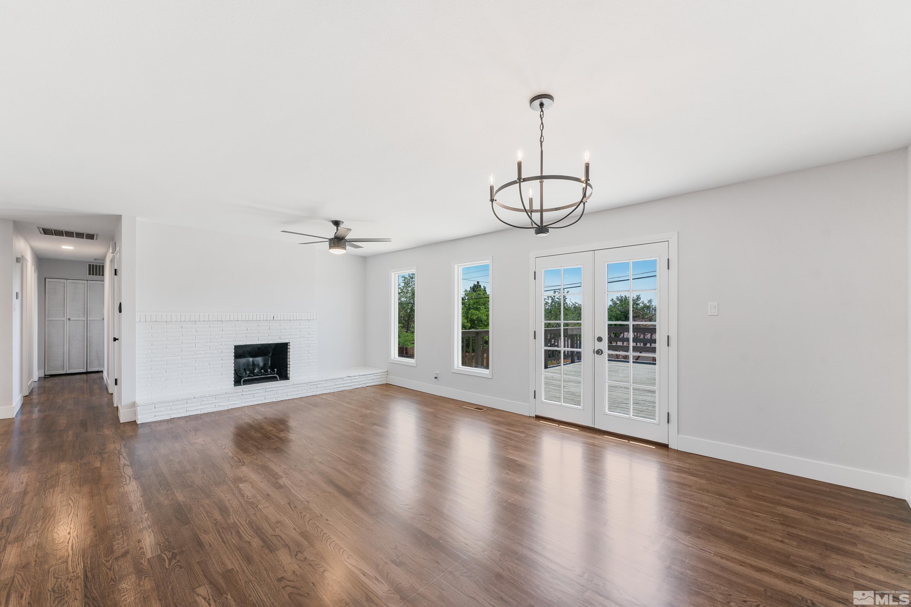 3380 Bryan Street Reno, NV 89503 - Photo 9 of 40 a view of a livingroom with wooden floor a ceiling fan and windows