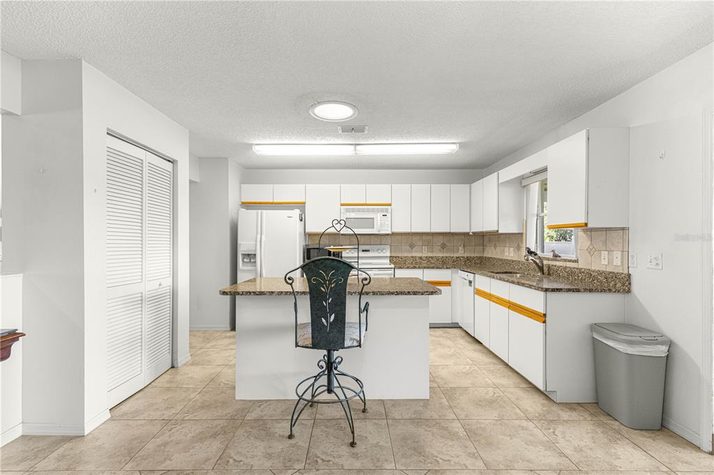 8962 Southwest 97th Street, Unit D Ocala, FL 34481 - Photo 12 of 56 a kitchen with a sink and chairs