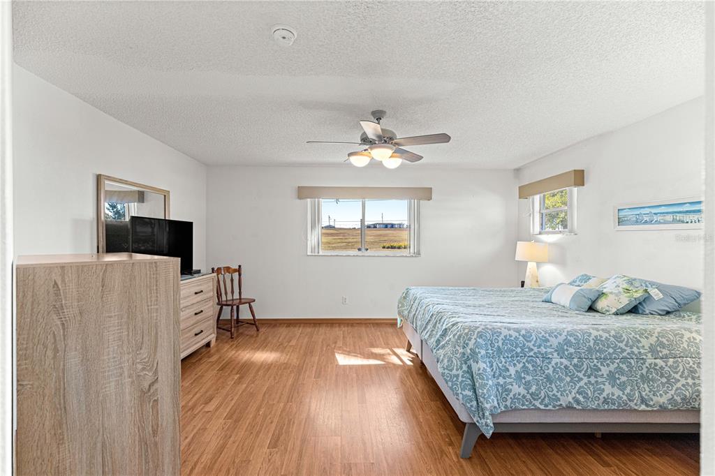 8962 Southwest 97th Street, Unit D Ocala, FL 34481 - Photo 23 of 56 a bedroom with a bed and a flat screen tv