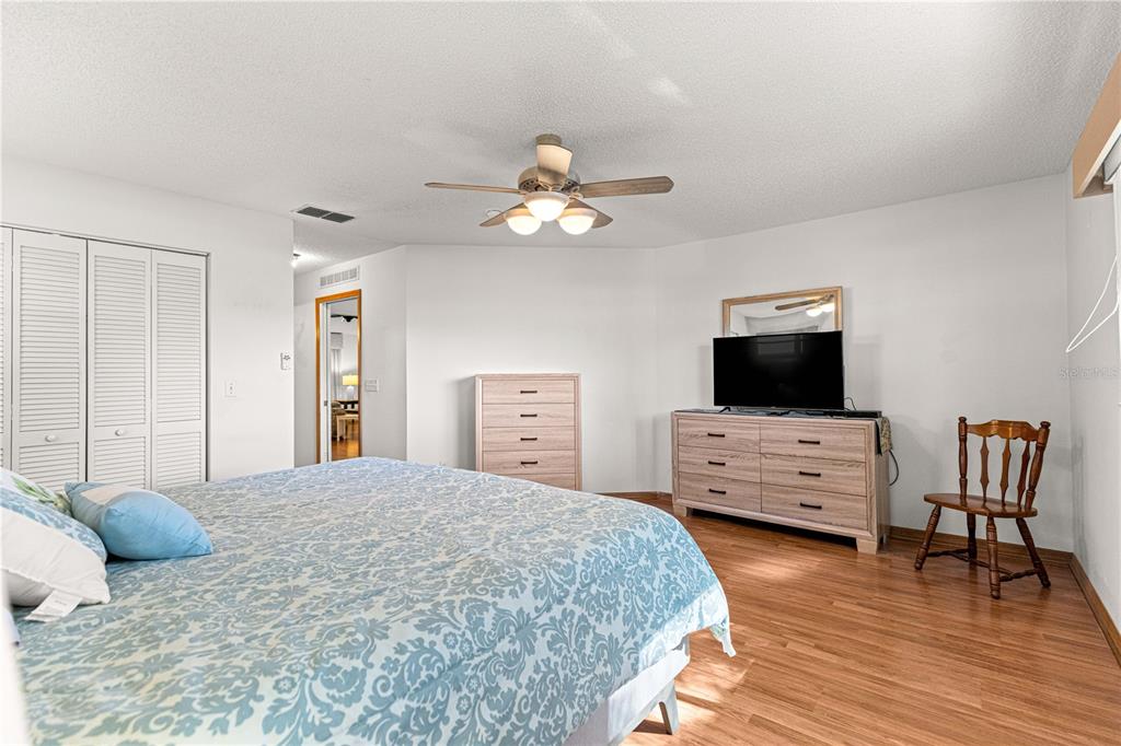 8962 Southwest 97th Street, Unit D Ocala, FL 34481 - Photo 24 of 56 a bedroom with a bed and a flat screen tv