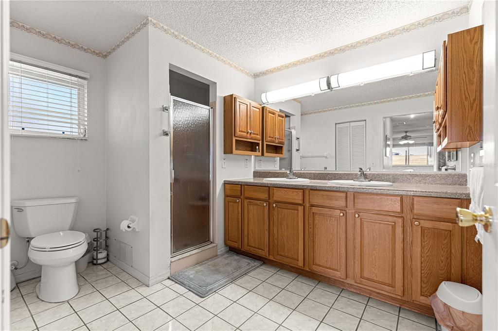 8962 Southwest 97th Street, Unit D Ocala, FL 34481 - Photo 26 of 56 a bathroom with a granite countertop sink toilet and shower